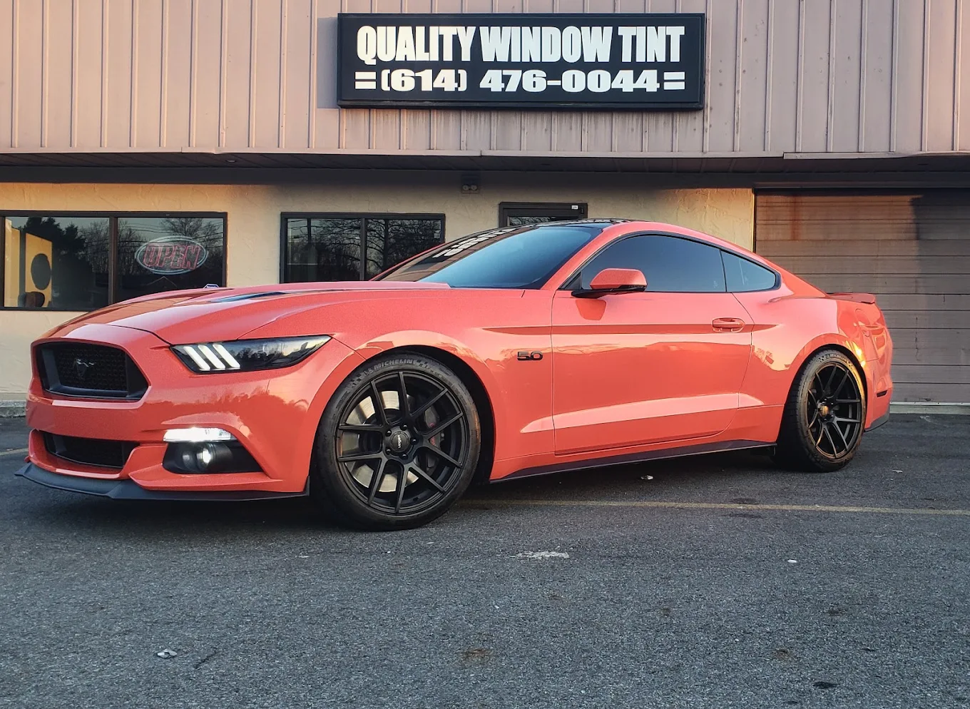 Red sports car outside shop