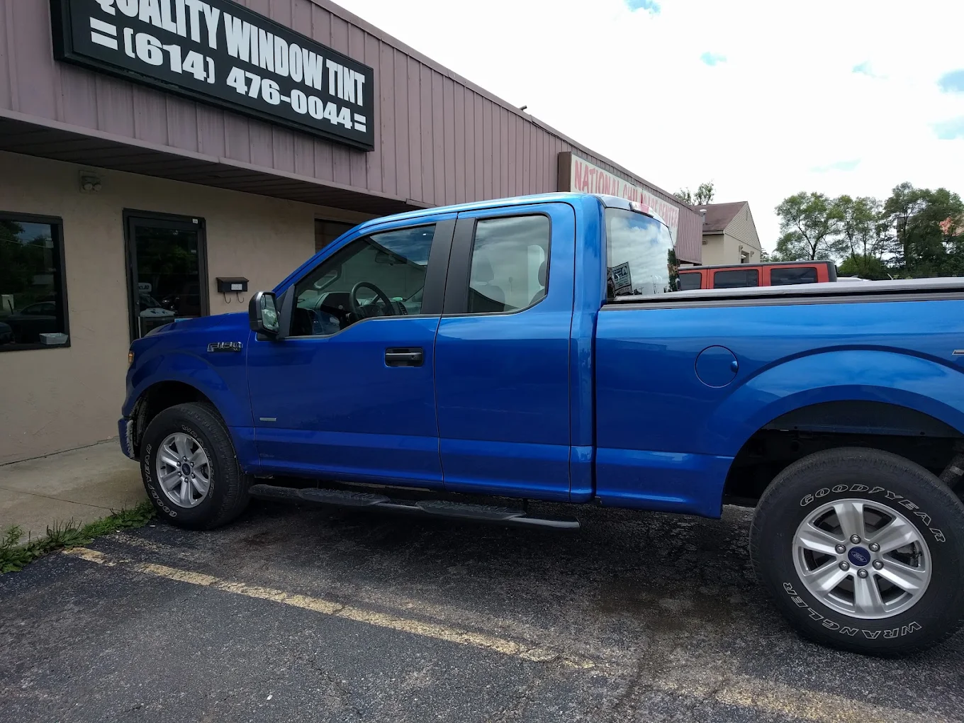 Blue pickup truck outside shop