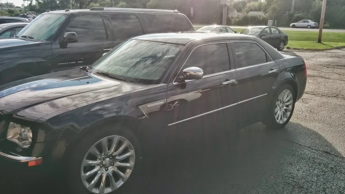 Black luxury sedan parked outside