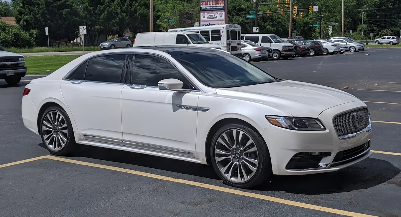 White luxury sedan parked with window tint