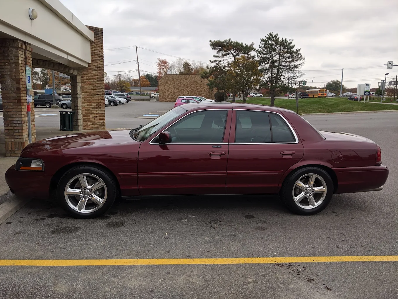 Maroon sedan in parking lot with window tint