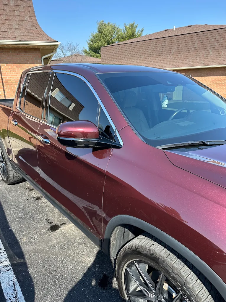 Maroon pickup truck parked outside