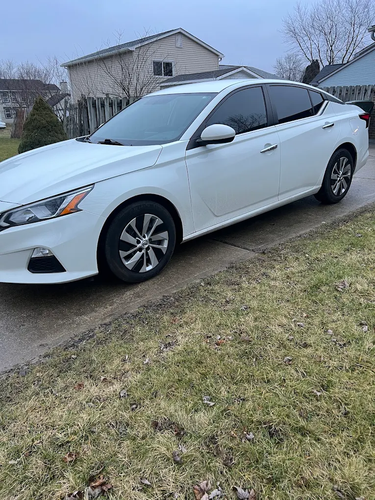 White sedan parked driveway